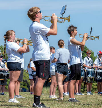 Members of the 39th Kansas Masonic All-Star Band practice on the Pittsburg State campus before the 2022 Kansas Shrine Bowl. Brayton Lind (center front) playing trumpet. | Photo Credit - Zane Schultze